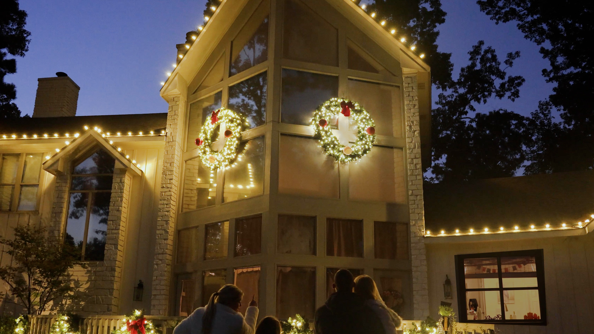 Residential home exterior professionally decorated with Christmas lights
